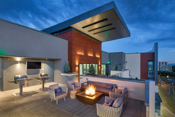 Rooftop patio with plush seating and built in BBQ grills overlooking Cherry Creek street.