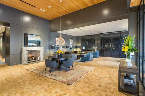 Lounge with wood floor, plush seating, tiled fireplace, and eclectic decor.