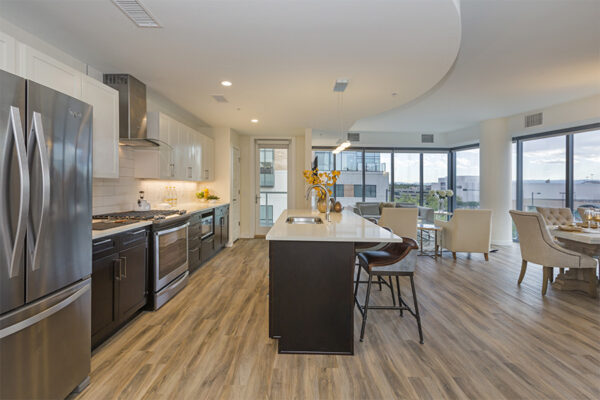 Living area with plush living room, elegant dining room, and modern kitchen.