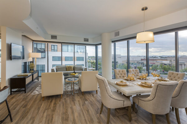 Living area with plush living room, elegant dining room, and floor to ceiling windows.