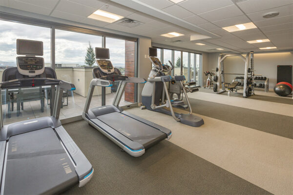 Fitness center with cardio machines and weight equipment.