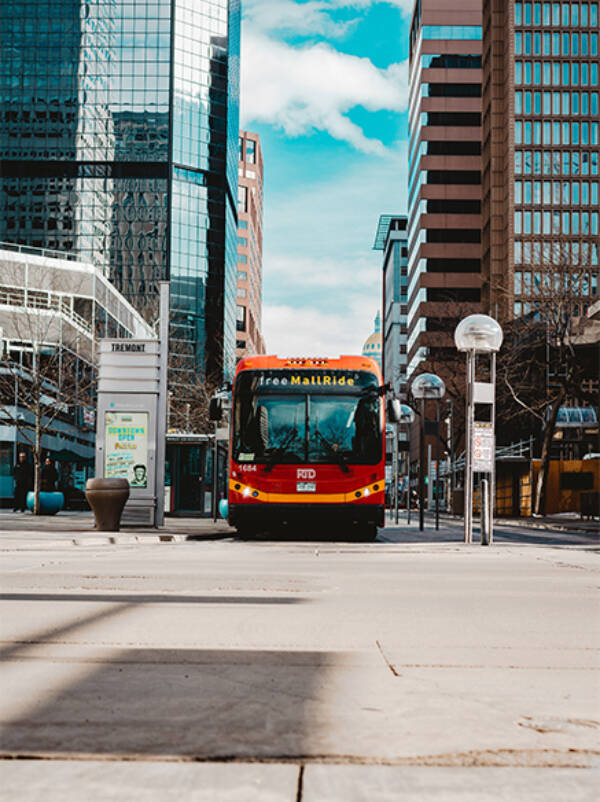 Shuttle bus driving along street in Denver.
