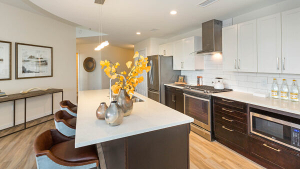 Apartment kitchen with appliances and dining island.