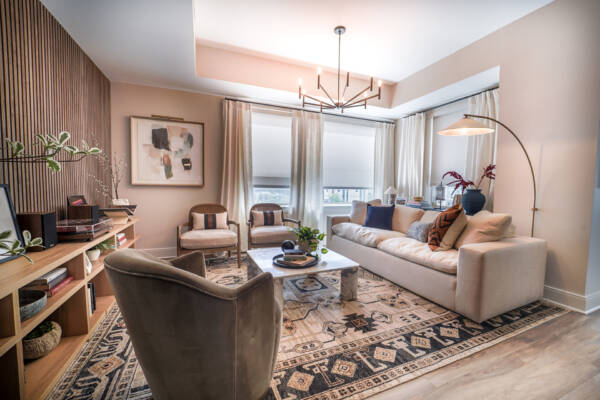 Updated Living Room with wood panel wall, updated light fixtures and modern furniture